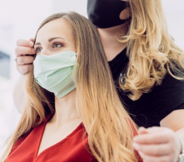 Mobile Hairstylist styling senior woman